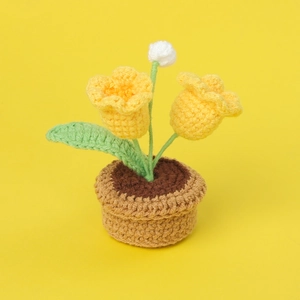 Detailed view of handmade yellow crochet tulip potted plant with intricate knit texture