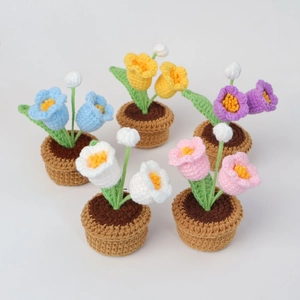 Detailed top view of five handmade crochet lily of the valley potted plants in vibrant colors