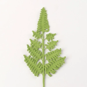 Handmade crochet fern leaf decor made with vibrant green yarn for DIY wedding floral gifts