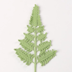 Handmade crochet fern leaf knit artificial plant decoration on white background