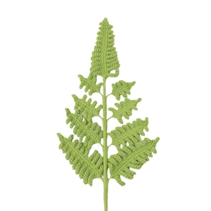 Handmade crochet green fern leaf with intricate knit texture on a white background