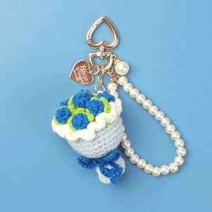 Detail of handmade crochet flower bouquet keychain with pearl chain and heart clasp