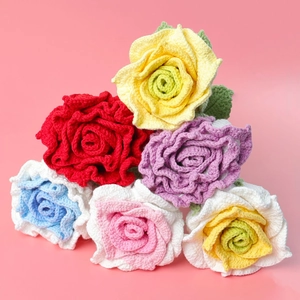 Macro shot of colorful handmade crochet roses showing detailed yarn texture and craftsmanship