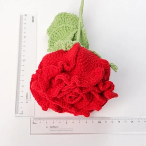 Handmade crochet red rose bouquet with green leaves and realistic knitted texture