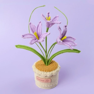 Detailed macro view of handmade crochet potted Zephyranthes with soft purple petals