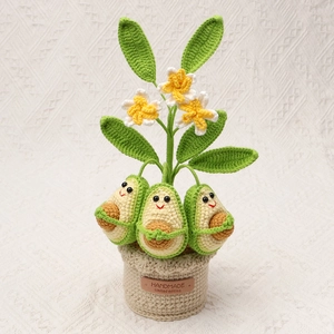 Handmade crochet potted avocado plants with smiling faces and floral accents for home decor