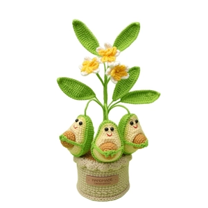 Handmade crochet avocado potted plant with green leaves and a handmade leather label