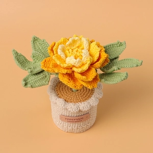 Macro detail of handmade crochet yellow peony flower in a beige knitted pot