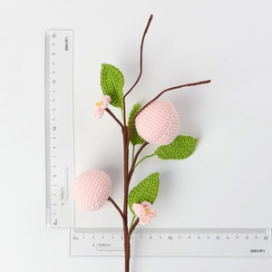 Close-up of handmade crochet peach branch showing precise 20cm scale on white background