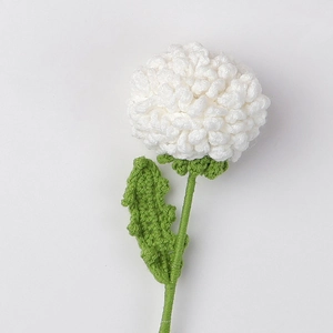 Detailed close-up of handmade crochet pompon mum flower with green stem and soft petals