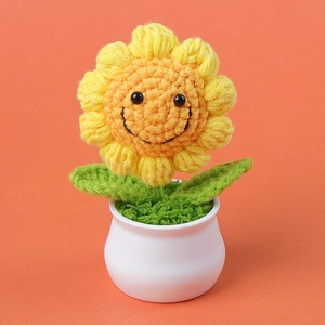 Handmade crochet sunflower potted plant with a smile face in a white ceramic pot