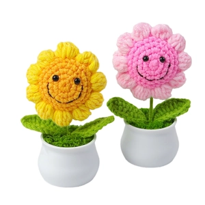 Handmade crochet sunflower potted plants with smiley faces and white ceramic bases