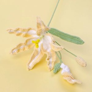 Detailed close-up of handmade crochet daylily with yellow cotton petals and green stem