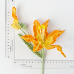 Detailed view of handmade crochet lily with ruler showing 16cm width and 19cm height