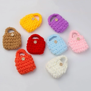 Flat lay of colorful handmade crochet mini bags with wooden buttons in eight vibrant colors
