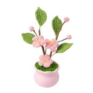 Handmade crochet pink cherry blossom potted plant with knitted leaves and pink textured pot