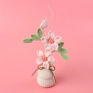Handmade crochet clematis flower in beige pot with pink blossoms for home decor