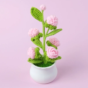 Handmade crochet pink rose flower pot in a white scalloped vase for desk decoration