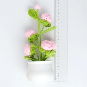 Handmade crochet pink rose potted plant decor with white ceramic pot and ruler for scale