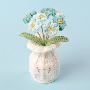 Detailed handmade crochet blue flower in white pot with 'Handmade WITH LOVE' label