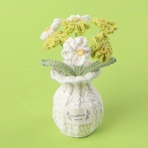 Detail of handmade crochet forget-me-not potted plant with HandMade WITH LOVE label