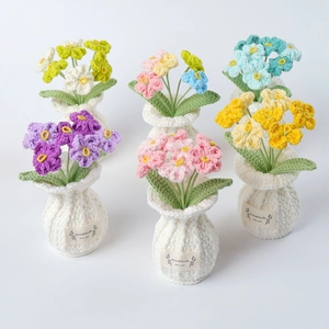 Set of six handmade crochet potted flowers in pastel colors with handmade labels