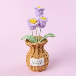 Macro shot of handmade crochet purple tulip bonsai with HandMade label and knit texture