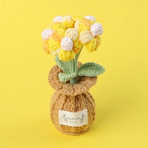Detailed macro view of handmade crochet sunflower potted plant with soft yarn texture