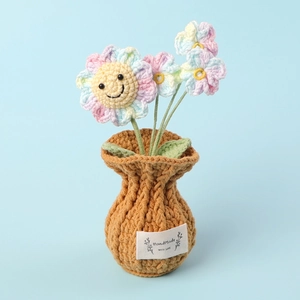Detailed close-up of handmade crochet orchid flowers in a textured brown knitted pot