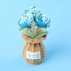 Detailed texture of handmade crochet blue orchids with HandMade WITH LOVE label