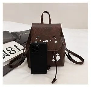 Detailed size comparison of a dark brown mini cat backpack next to a smartphone