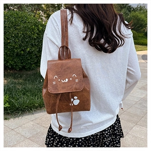 Rear view detail of a cute brown leather mini backpack with cat print and drawstrings