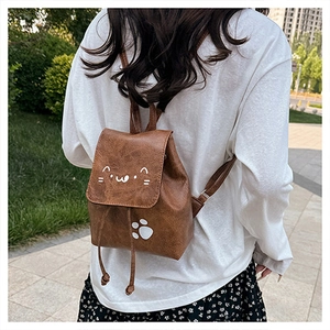 Detail of vintage brown PU leather mini backpack with cute cat print and drawstring cover