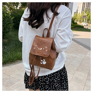 Close-up of brown PU leather backpack featuring cute cat embroidery and paw prints