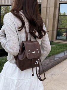 Deep brown retro mini backpack with cute cat graphics and adjustable shoulder straps