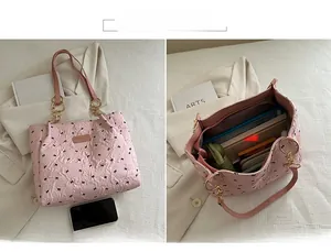 Detailed view of pink quilted tote bag with black bows and interior storage capacity