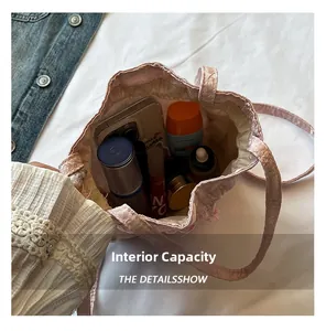 Top view of pink pleated bucket bag interior showing spacious storage for cosmetics