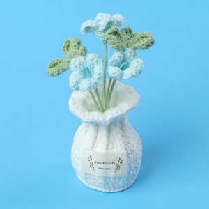 Close-up of handmade crochet blue flower in pot with HandMade WITH LOVE label