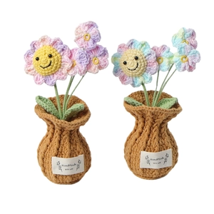 Handmade crochet sunflower potted plants with smiling faces in pink and blue gradients