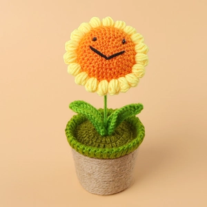 Handmade crochet sunflower plant in rustic pot with a cute smiling face for desk decor