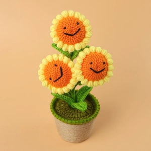 Handmade crochet sunflower potted plant with smiling faces and rustic jute rope pot