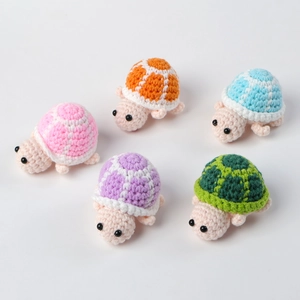 Detailed view of five colorful handmade crochet mini turtles with intricate knitted textures