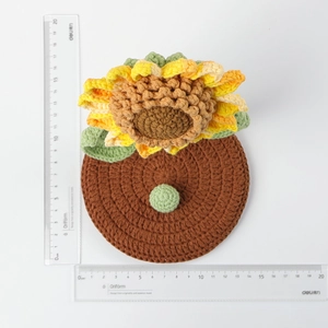 Detailed top view of handmade crochet sunflower phone stand with measuring rulers
