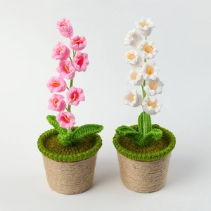 Close-up of handmade crochet Lily of the Valley potted flowers with detailed yarn texture