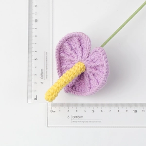 Detail of hand-crocheted purple anthurium flower showing 6cm size with ruler measurement
