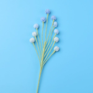 Detail of handcrafted crochet blue flowers with soft yarn texture for home decoration