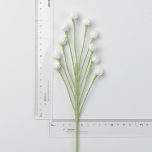 Macro detail of handmade crochet yarn flowers with white buds on a long green stem