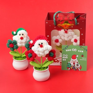 Detail of handmade crochet Santa Claus potted plants with gift bag and holiday card