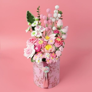 Ramo de flores de ganchillo hecho a mano en cubo floral rosa con borlas elegantes