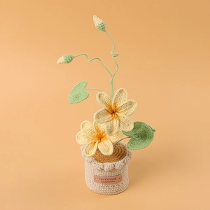 Close-up of handmade crochet yellow flowers in a knitted pot with handmade leather label